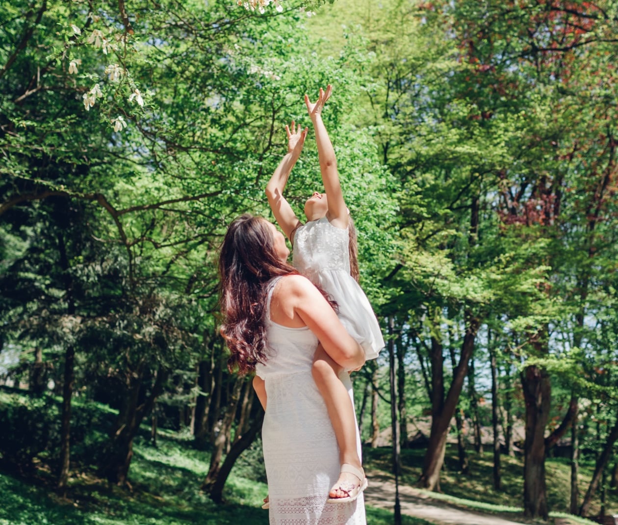 child reaching for trees