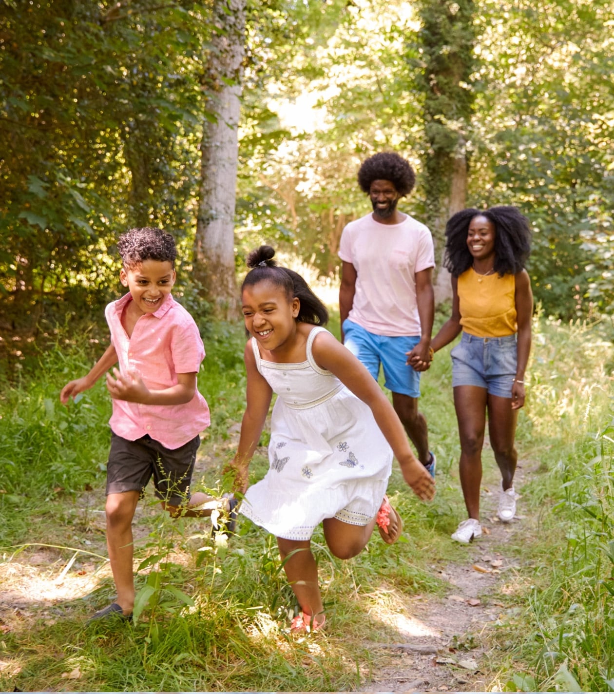 Children running through forest